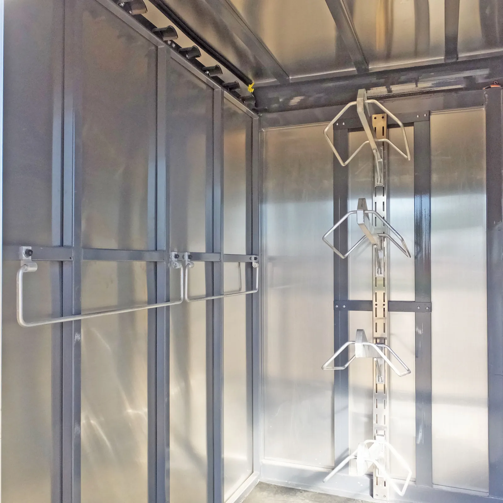 Tack wall with bridle hooks and blanket bars.